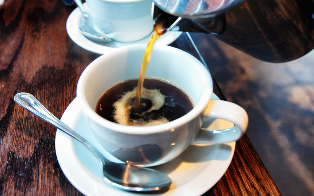 Cup of coffee being poured